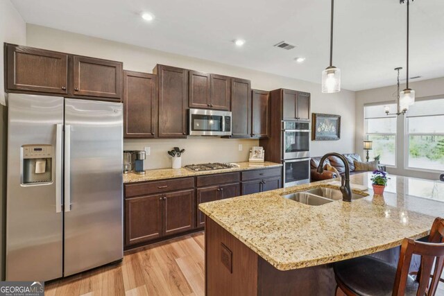 67 Narrowleaf Ln, Dallas, GA 30157 - kitchen featuring dark brown cabinetry, visible vents, a sink, and stainless steel appliances