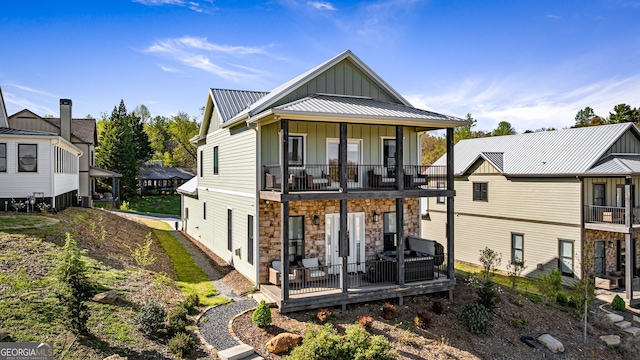 24 Harrison Ln, Blue Ridge, GA 30513 - rear view of property featuring metal roof, a balcony, board and batten siding, and stone siding