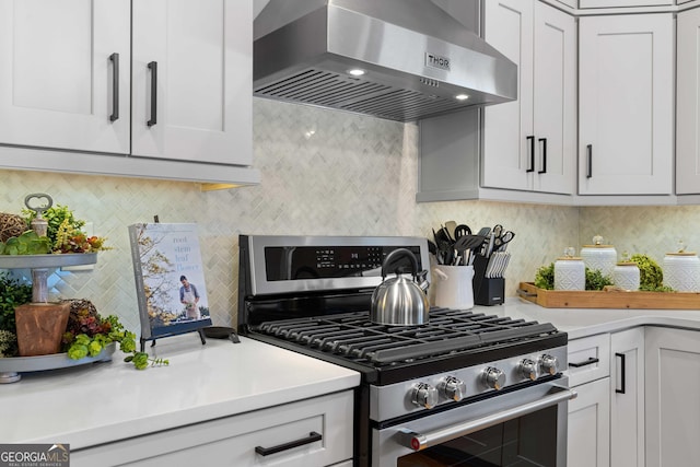 24 Harrison Ln, Blue Ridge, GA 30513 - kitchen with wall chimney range hood, light countertops, white cabinetry, decorative backsplash, and stainless steel range with gas cooktop