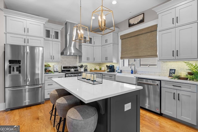 24 Harrison Ln, Blue Ridge, GA 30513 - kitchen featuring wall chimney range hood, a center island, a sink, stainless steel appliances, and a notable chandelier