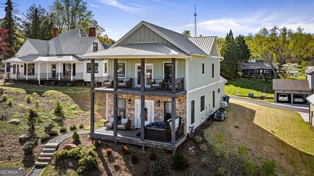 24 Harrison Ln, Blue Ridge, GA 30513 - rear view of house featuring board and batten siding, a standing seam roof, a yard, metal roof, and stone siding
