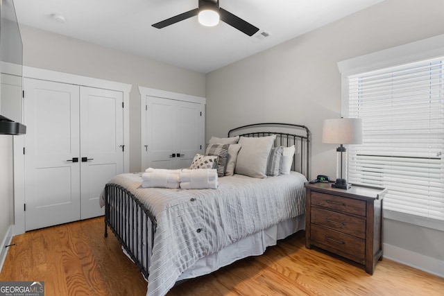 24 Harrison Ln, Blue Ridge, GA 30513 - bedroom with two closets, ceiling fan, visible vents, light wood finished floors, and baseboards