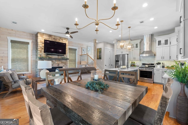 24 Harrison Ln, Blue Ridge, GA 30513 - dining area featuring ceiling fan with notable chandelier, a fireplace, light wood-style flooring, visible vents, and recessed lighting