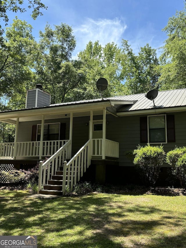 575 Lake Laurel Rd, Milledgeville, GA 31061 - exterior space with a chimney, a front yard, and a porch