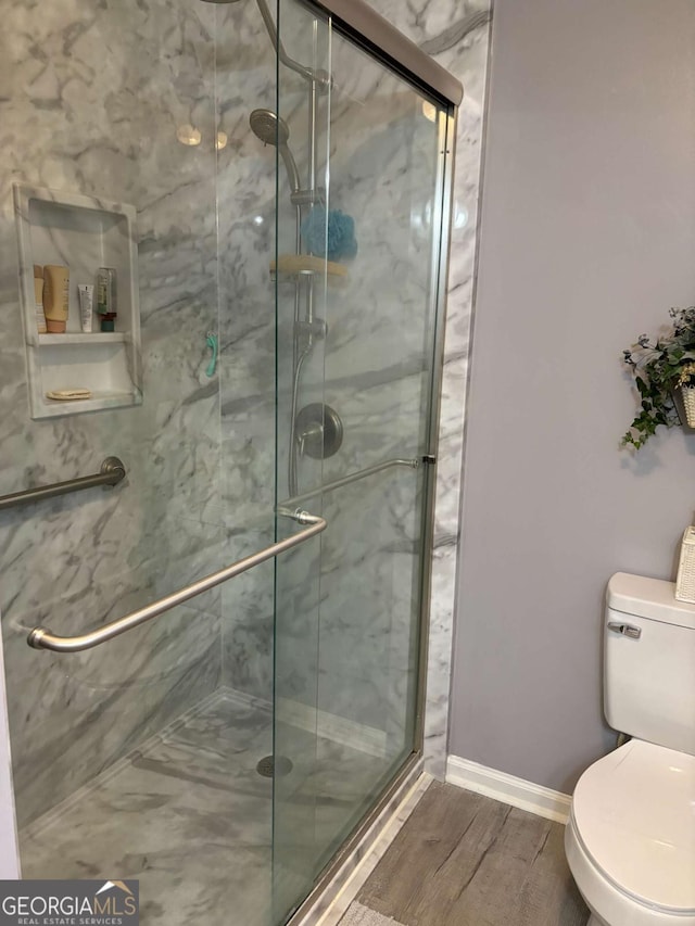 575 Lake Laurel Rd, Milledgeville, GA 31061 - bathroom with toilet, baseboards, a shower stall, and wood finished floors
