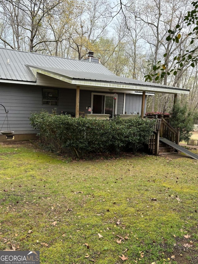 575 Lake Laurel Rd, Milledgeville, GA 31061 - rear view of house featuring a lawn, metal roof, and a chimney