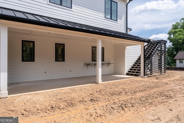 2650 Roswell Rd, Marietta, GA 30062 - rear view of house with stairway, a standing seam roof, a metal roof, and a patio area