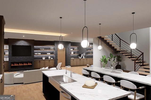 2650 Roswell Rd, Marietta, GA 30062 - kitchen with a sink, an island with sink, light stone counters, hanging light fixtures, and stainless steel dishwasher