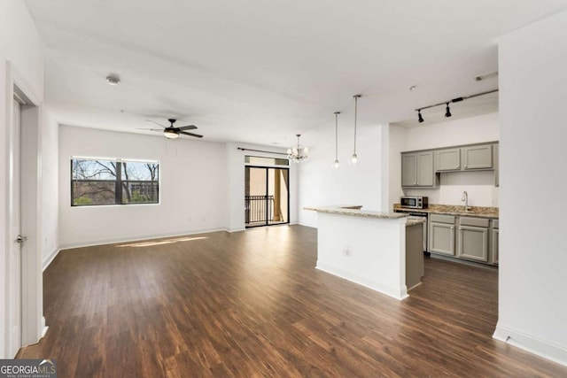 2230 Cheshire Bridge Rd NE Unit 410, Atlanta, GA 30324 - kitchen with open floor plan, rail lighting, gray cabinets, ceiling fan with notable chandelier, and dark wood-style floors
