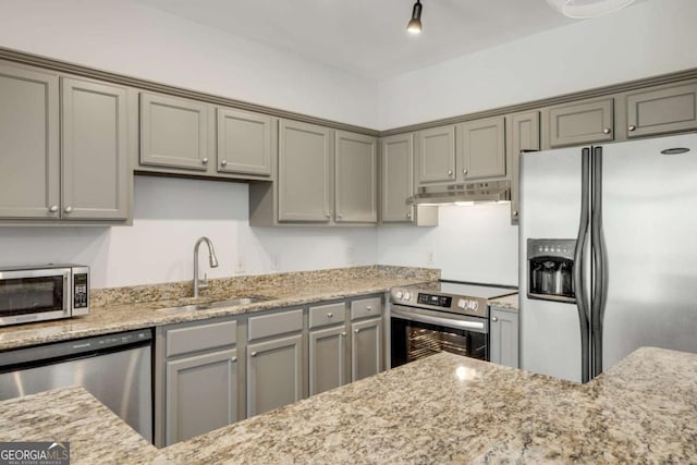 2230 Cheshire Bridge Rd NE Unit 410, Atlanta, GA 30324 - kitchen featuring light stone countertops, appliances with stainless steel finishes, under cabinet range hood, a sink, and gray cabinets