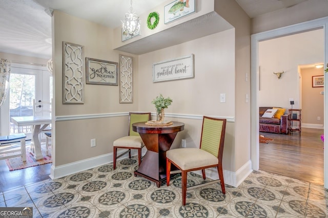 667 Cardinal Dr, Monticello, GA 31064 - living area with tile patterned flooring, a notable chandelier, and baseboards
