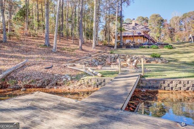 667 Cardinal Dr, Monticello, GA 31064 - view of dock with a lawn, stairs, and a wooden deck