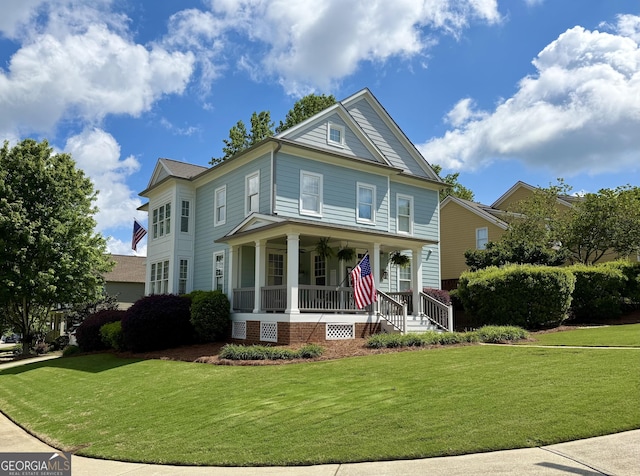 5753 Porch Swing Pl, Hoschton, GA 30548 - view of front of property with covered porch and a front lawn