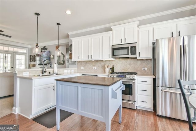 5753 Porch Swing Pl, Hoschton, GA 30548 - kitchen with appliances with stainless steel finishes, a sink, white cabinetry, crown molding, and decorative backsplash