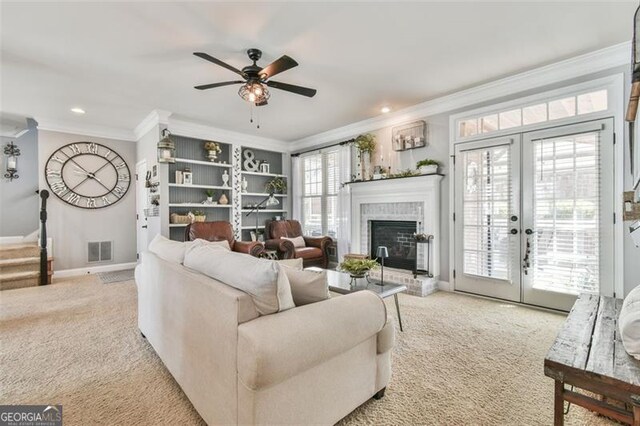 5753 Porch Swing Pl, Hoschton, GA 30548 - carpeted living area with crown molding, ceiling fan, a fireplace, recessed lighting, and french doors