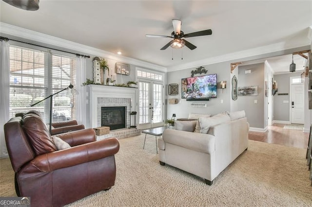 5753 Porch Swing Pl, Hoschton, GA 30548 - carpeted living room with ornamental molding, a ceiling fan, and a brick fireplace