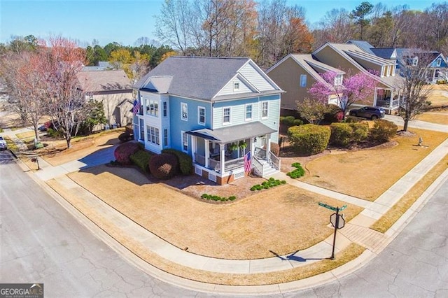 5753 Porch Swing Pl, Hoschton, GA 30548 - traditional home featuring a porch, driveway, and a residential view