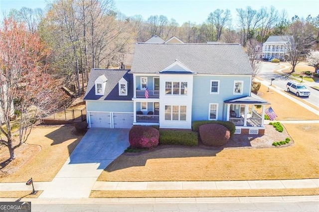 5753 Porch Swing Pl, Hoschton, GA 30548 - view of front of house with a porch, a balcony, driveway, and a garage