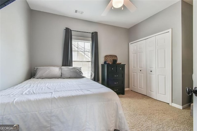 5753 Porch Swing Pl, Hoschton, GA 30548 - bedroom featuring light colored carpet, a closet, and a ceiling fan