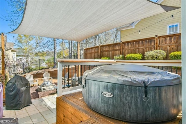 5753 Porch Swing Pl, Hoschton, GA 30548 - wooden deck featuring a hot tub, a fenced backyard, area for grilling, and a patio area