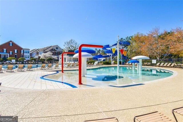 5753 Porch Swing Pl, Hoschton, GA 30548 - community pool featuring a water play area and a residential view