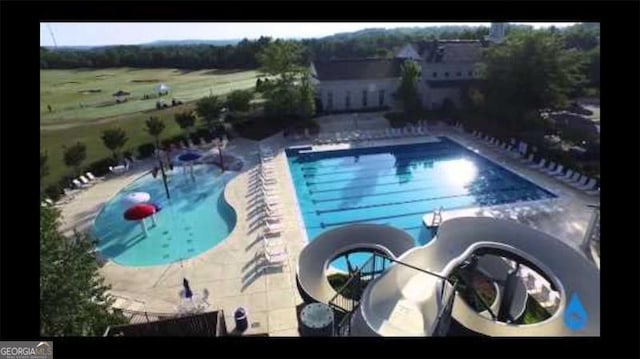 5753 Porch Swing Pl, Hoschton, GA 30548 - community pool featuring a patio area