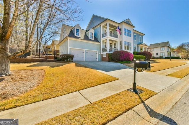 5753 Porch Swing Pl, Hoschton, GA 30548 - view of front of house with concrete driveway, an attached garage, and a balcony