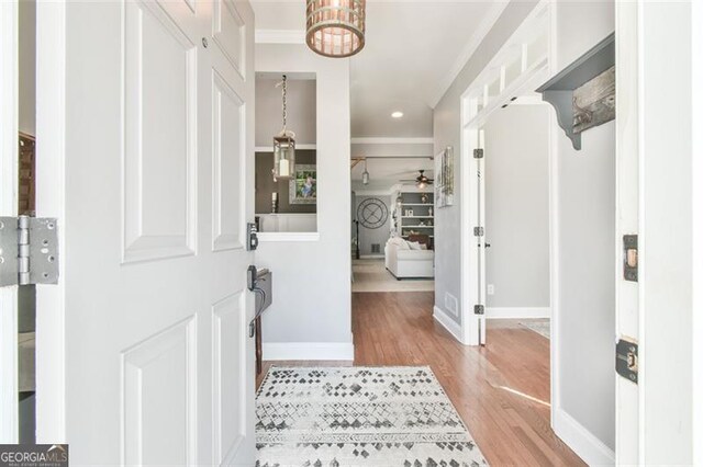 5753 Porch Swing Pl, Hoschton, GA 30548 - foyer with wood finished floors, ornamental molding, ceiling fan, a chandelier, and recessed lighting