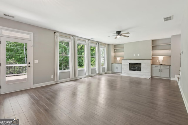 557 Winder Trl, Canton, GA 30114 - unfurnished living room with ceiling fan, plenty of natural light, a high end fireplace, and dark wood-type flooring