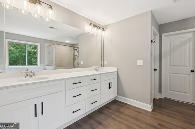 557 Winder Trl, Canton, GA 30114 - bathroom featuring double vanity, a stall shower, and wood finished floors