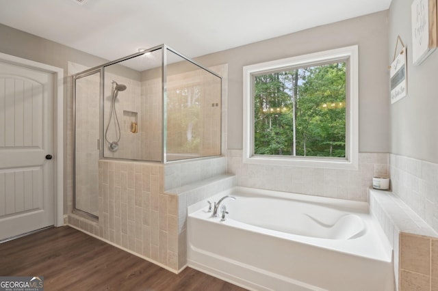 557 Winder Trl, Canton, GA 30114 - full bathroom featuring a bath, a stall shower, wood finished floors, and tile walls