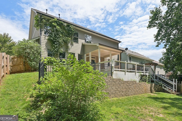 557 Winder Trl, Canton, GA 30114 - rear view of house featuring stairs and a wooden deck
