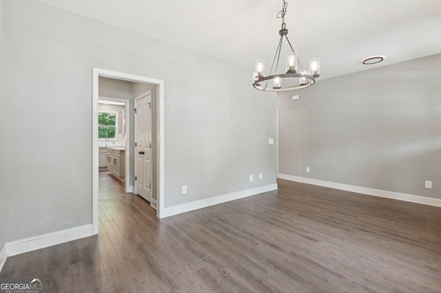 557 Winder Trl, Canton, GA 30114 - unfurnished room with a chandelier and dark wood-style floors