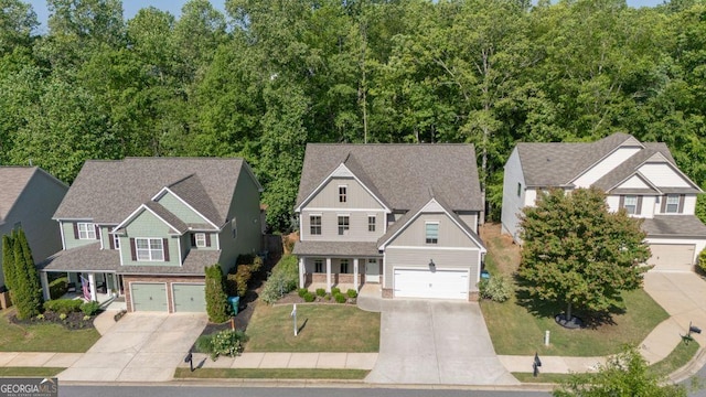 557 Winder Trl, Canton, GA 30114 - view of front facade featuring board and batten siding, driveway, a garage, and a front yard