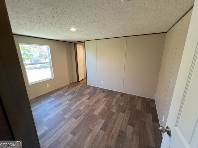 247 Hidden Valley Dr, Alto, GA 30510 - unfurnished bedroom with wood finished floors and a textured ceiling