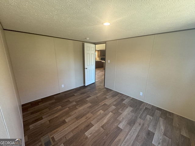 247 Hidden Valley Dr, Alto, GA 30510 - empty room featuring visible vents, dark wood-type flooring, and a textured ceiling