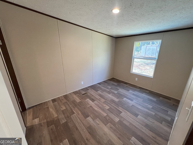 247 Hidden Valley Dr, Alto, GA 30510 - unfurnished bedroom with wood finished floors, ornamental molding, and a textured ceiling