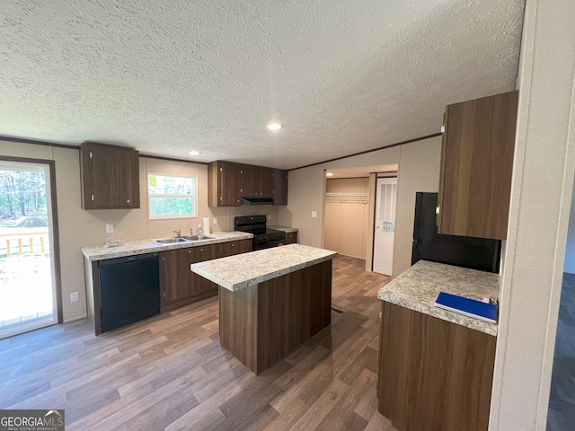 247 Hidden Valley Dr, Alto, GA 30510 - kitchen with light countertops, light wood-style flooring, a kitchen island, a sink, and black appliances