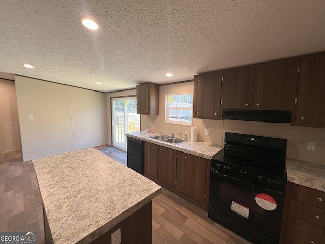 247 Hidden Valley Dr, Alto, GA 30510 - kitchen featuring light countertops, range hood, a sink, black appliances, and wood finished floors