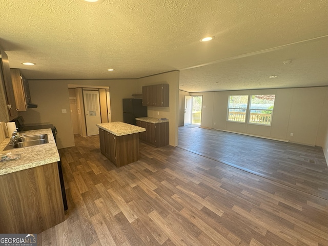 247 Hidden Valley Dr, Alto, GA 30510 - kitchen featuring light countertops, open floor plan, dark wood-style floors, a center island, and freestanding refrigerator