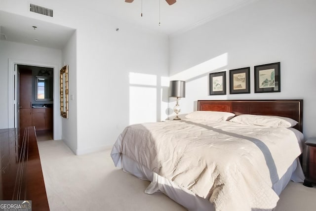 carpeted bedroom featuring a ceiling fan and visible vents