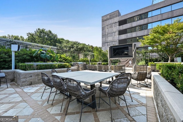 view of patio with outdoor dining area and an outdoor fireplace