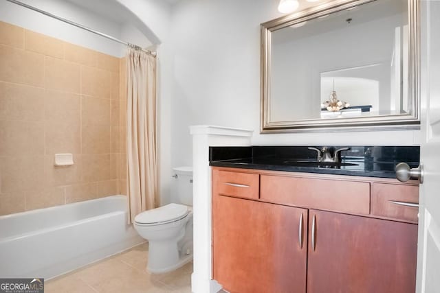bathroom featuring toilet, tile patterned floors, shower / bath combo with shower curtain, and vanity