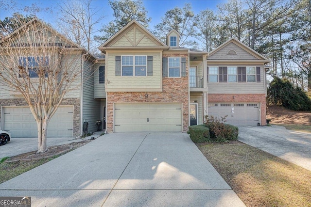 145 Sunset Ln, Woodstock, GA 30189 - townhome / multi-family property with concrete driveway, an attached garage, and stone siding