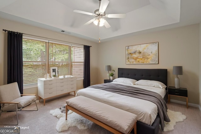 145 Sunset Ln, Woodstock, GA 30189 - bedroom featuring light carpet, a raised ceiling, baseboards, and a ceiling fan