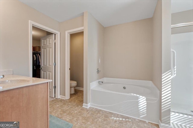 145 Sunset Ln, Woodstock, GA 30189 - full bathroom with toilet, a bath, a spacious closet, tile patterned flooring, and baseboards