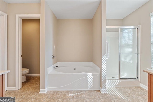 145 Sunset Ln, Woodstock, GA 30189 - bathroom featuring toilet, a stall shower, a bath, and baseboards