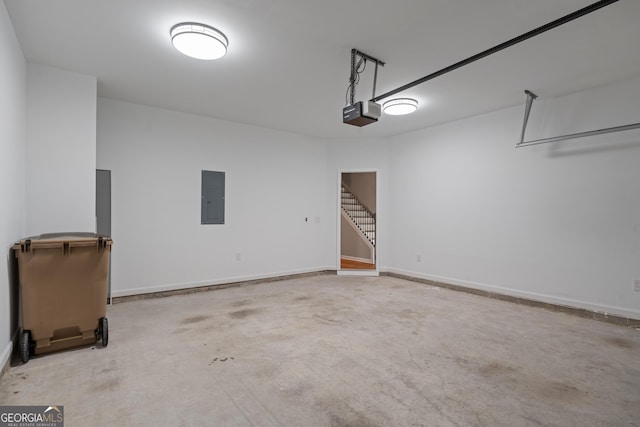 145 Sunset Ln, Woodstock, GA 30189 - garage with electric panel, a garage door opener, and baseboards
