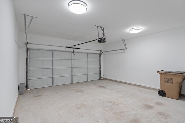 145 Sunset Ln, Woodstock, GA 30189 - garage featuring a garage door opener and baseboards
