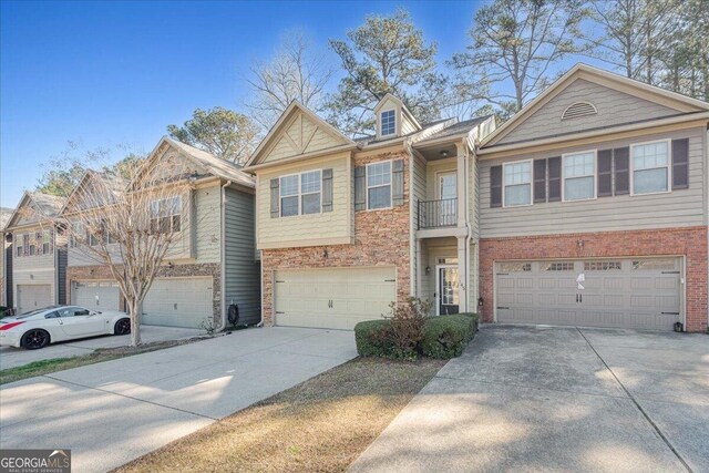 145 Sunset Ln, Woodstock, GA 30189 - view of property with driveway, a garage, and brick siding